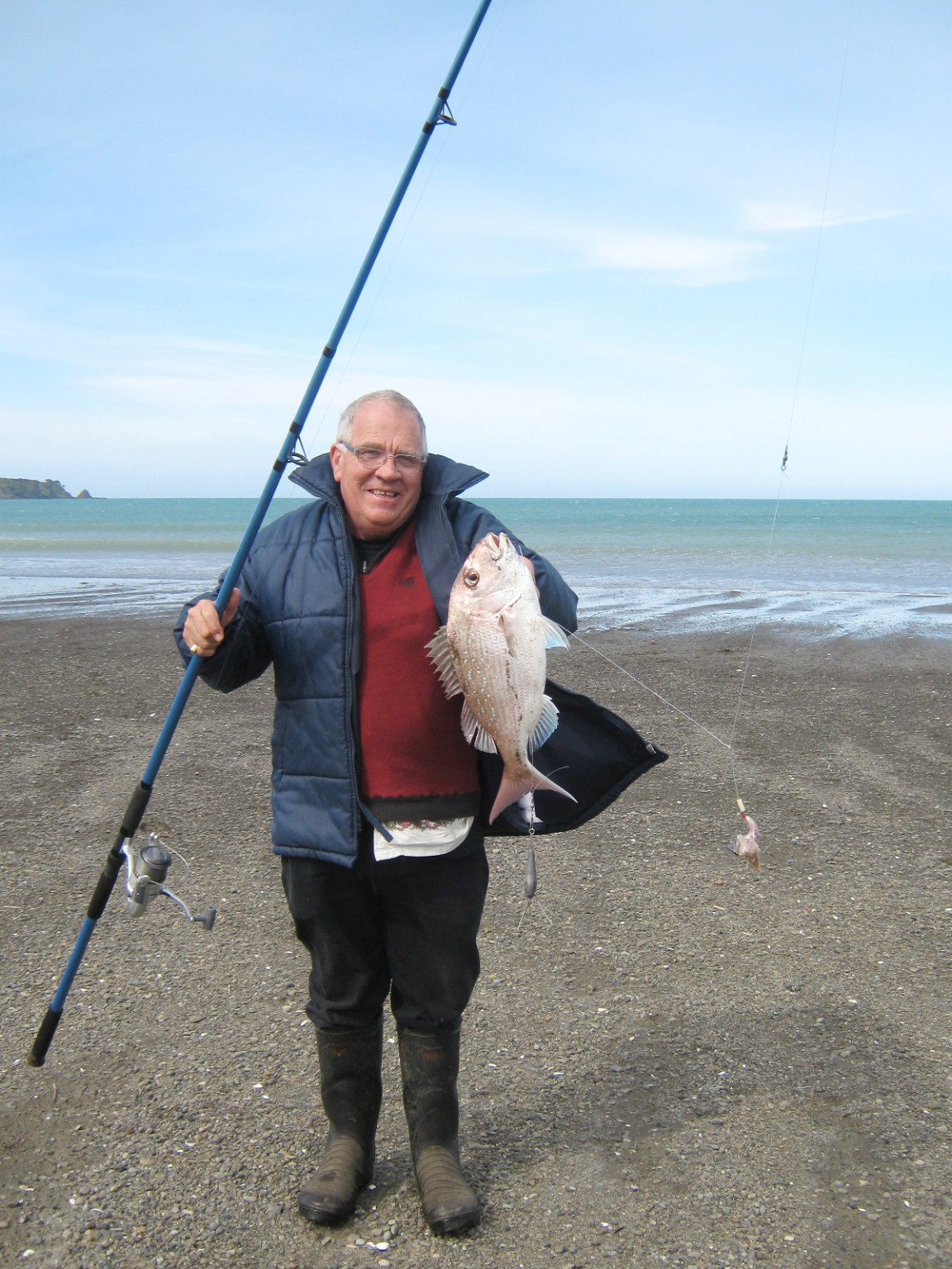 Man on the beach with a snapper