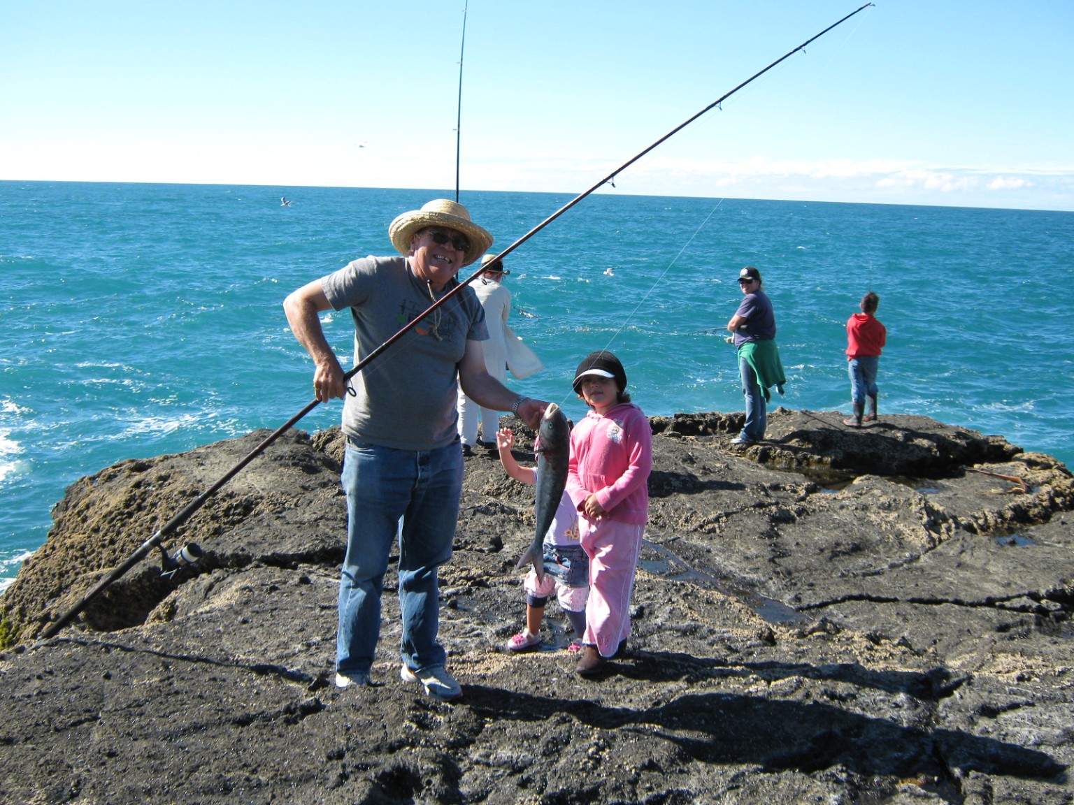 Family on the rocks fishing
