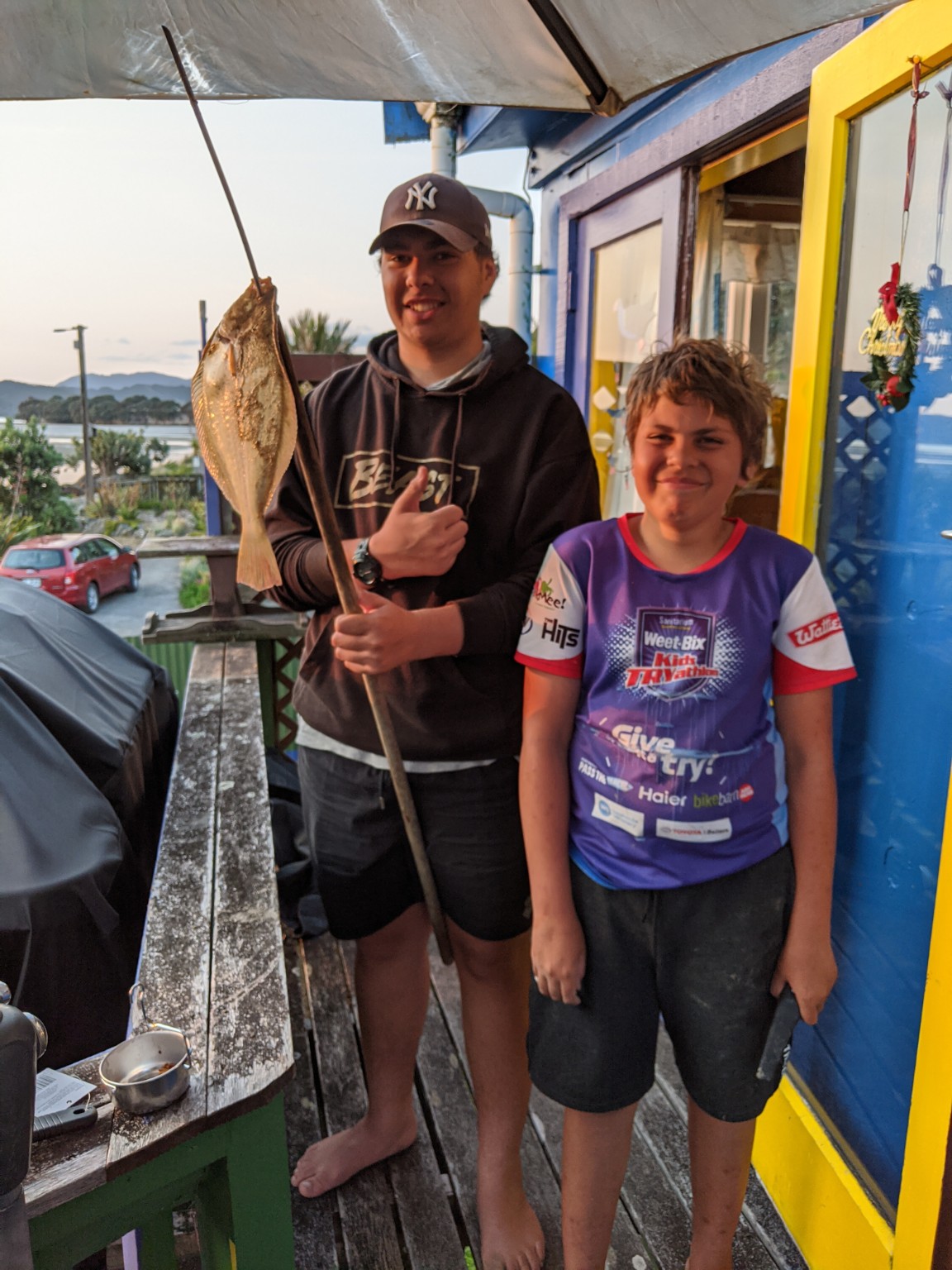 Two boys with a flat fish