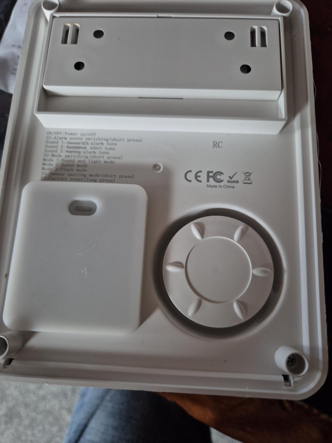 Rear of solar alarm showing bracket and siren